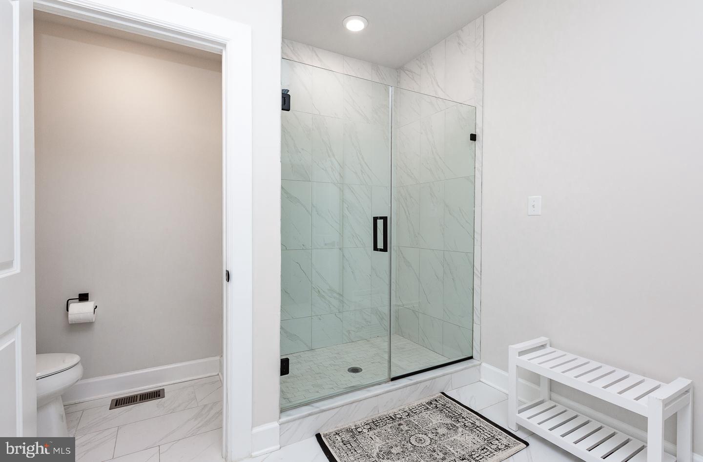 21 The Lane Wayne, PA 19087 - Photo 22 of 57 a bathroom with a shower a toilet and sink