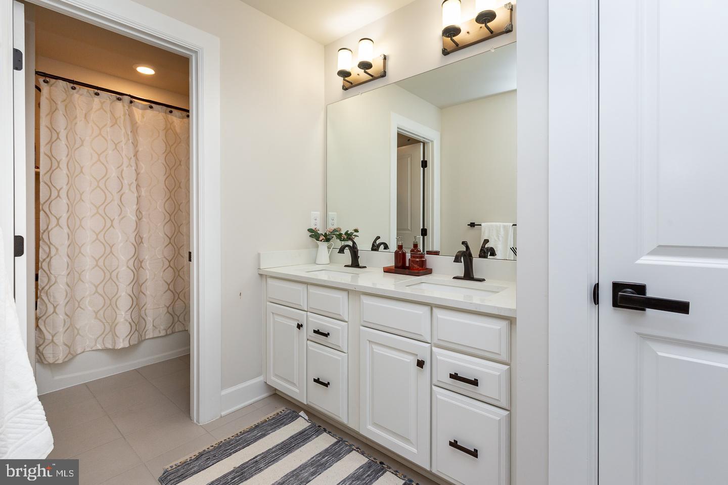 21 The Lane Wayne, PA 19087 - Photo 35 of 57 a bathroom with a sink double vanity and a mirror