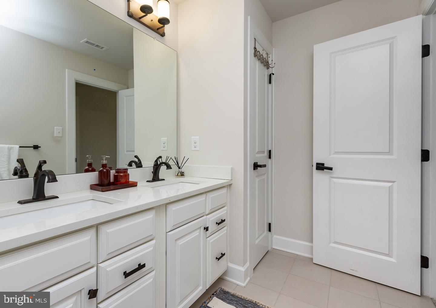 21 The Lane Wayne, PA 19087 - Photo 36 of 57 a bathroom with double sink and a mirror