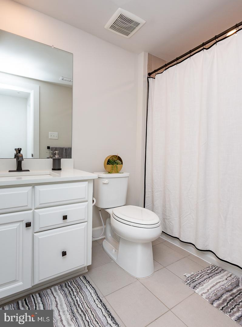 21 The Lane Wayne, PA 19087 - Photo 39 of 57 a bathroom with a toilet a sink and a mirror