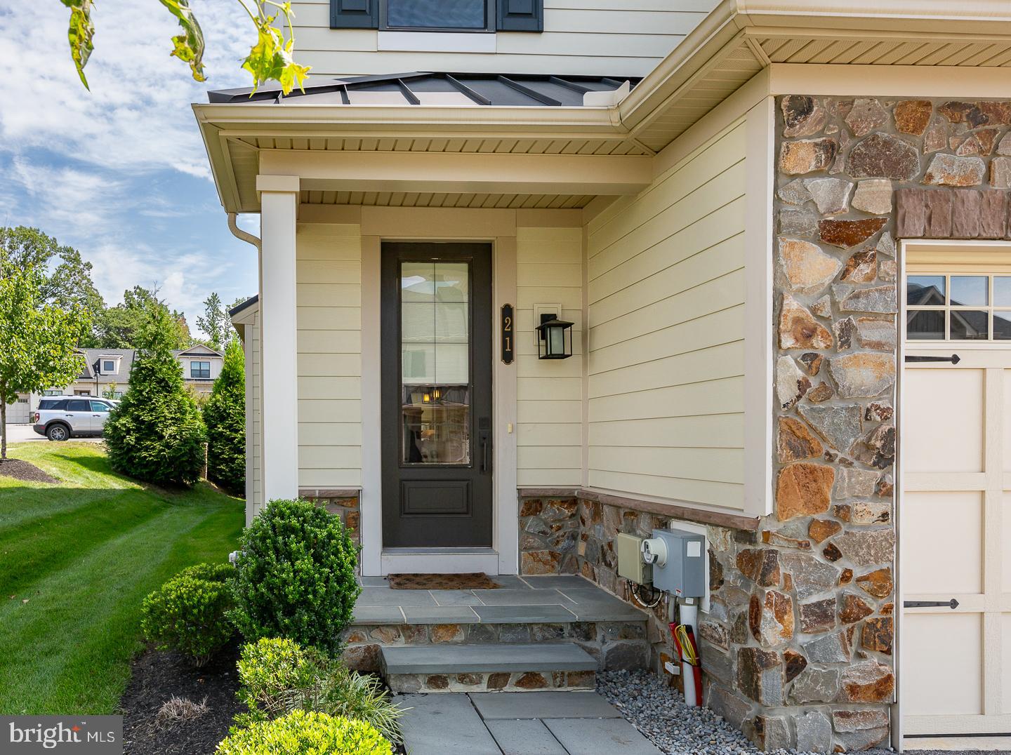 21 The Lane Wayne, PA 19087 - Photo 4 of 57 a front view of a house with a garden