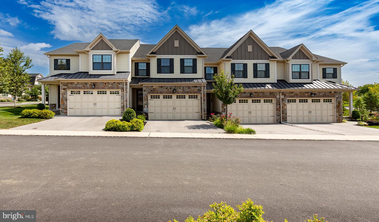 21 The Lane Wayne, PA 19087 - Photo 46 of 57 a front view of a house with a yard and garage