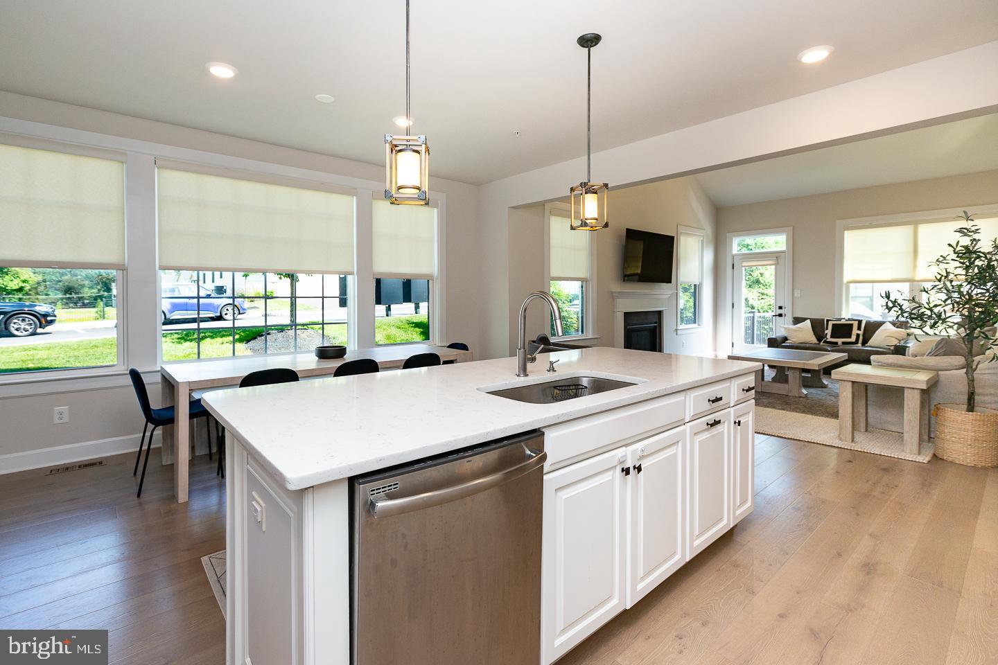 21 The Lane Wayne, PA 19087 - Photo 9 of 57 a kitchen with kitchen island a counter space a sink appliances and a large window
