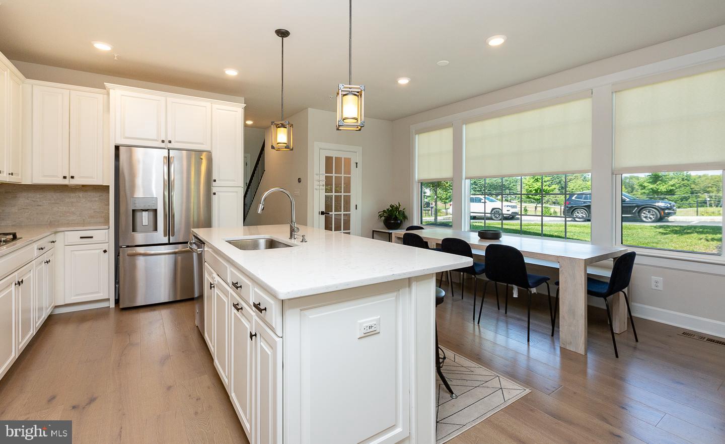 21 The Lane Wayne, PA 19087 - Photo 10 of 57 a kitchen with a table chairs stove and refrigerator
