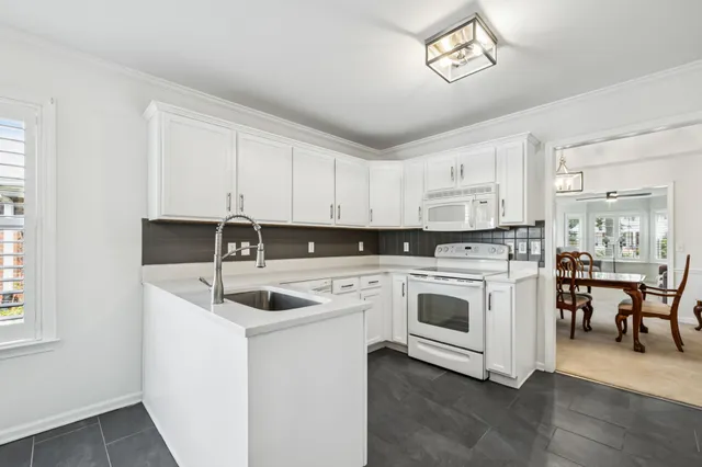 a kitchen with a sink cabinets and window