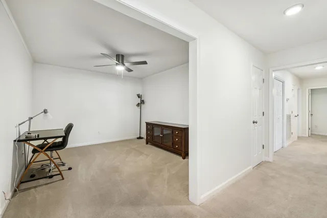 a view of a livingroom with furniture and a ceiling fan