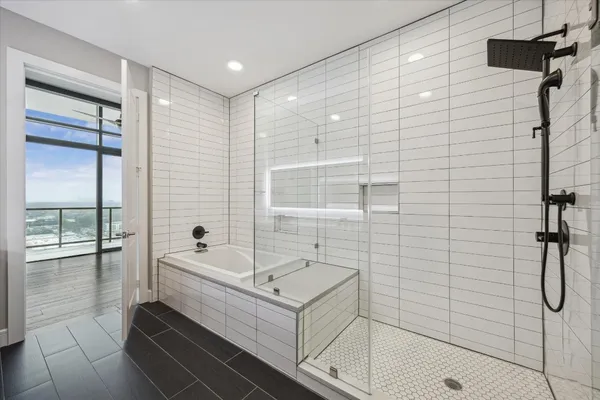 a bathroom with a tub and a shower