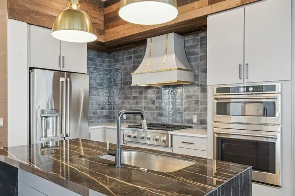 a kitchen with a sink cabinets and appliances