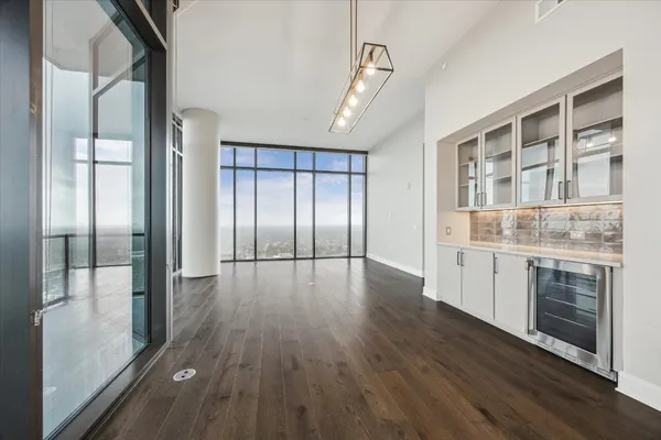 a view of a kitchen with stainless steel appliances granite countertop a refrigerator and a stove top oven