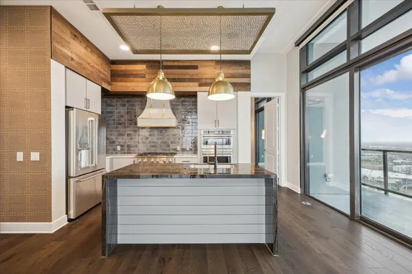 a bathroom with a granite countertop sink a mirror and shower