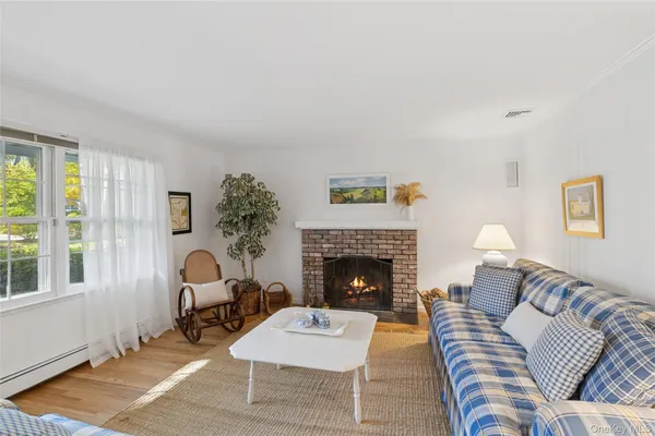 a living room with fireplace furniture dining table and a fireplace