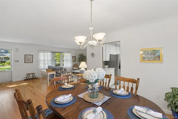 a dining room with furniture a rug and wooden floor