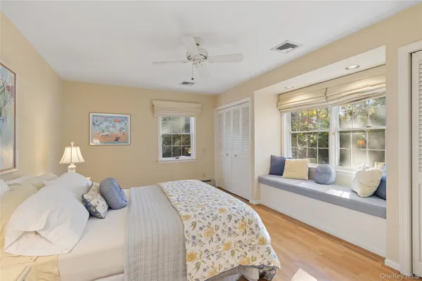 a bedroom with a large bed and a window