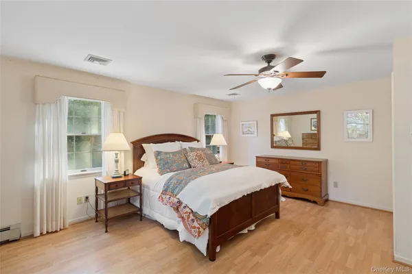 a bedroom with a large bed and a chandelier