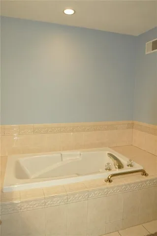 a bathroom with a toilet and a bathtub