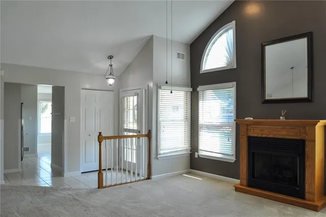 a view of a livingroom with a fireplace and window