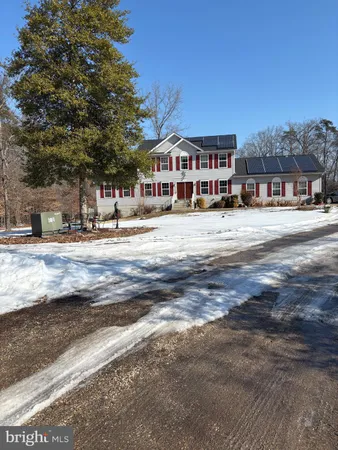 a front view of a building with a garden