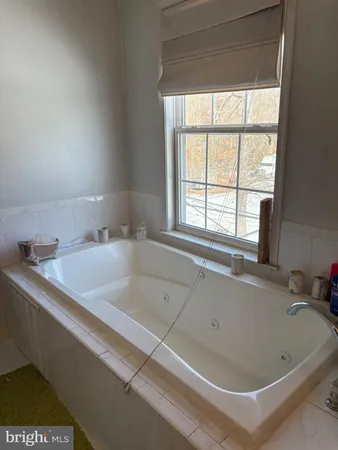 a bath tub sitting next to a window