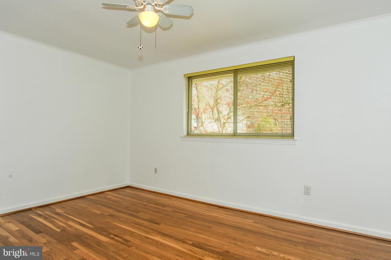 6910 Vancouver Road Springfield, VA 22152 - Photo 14 of 28 a view of an empty room with wooden floor and a window