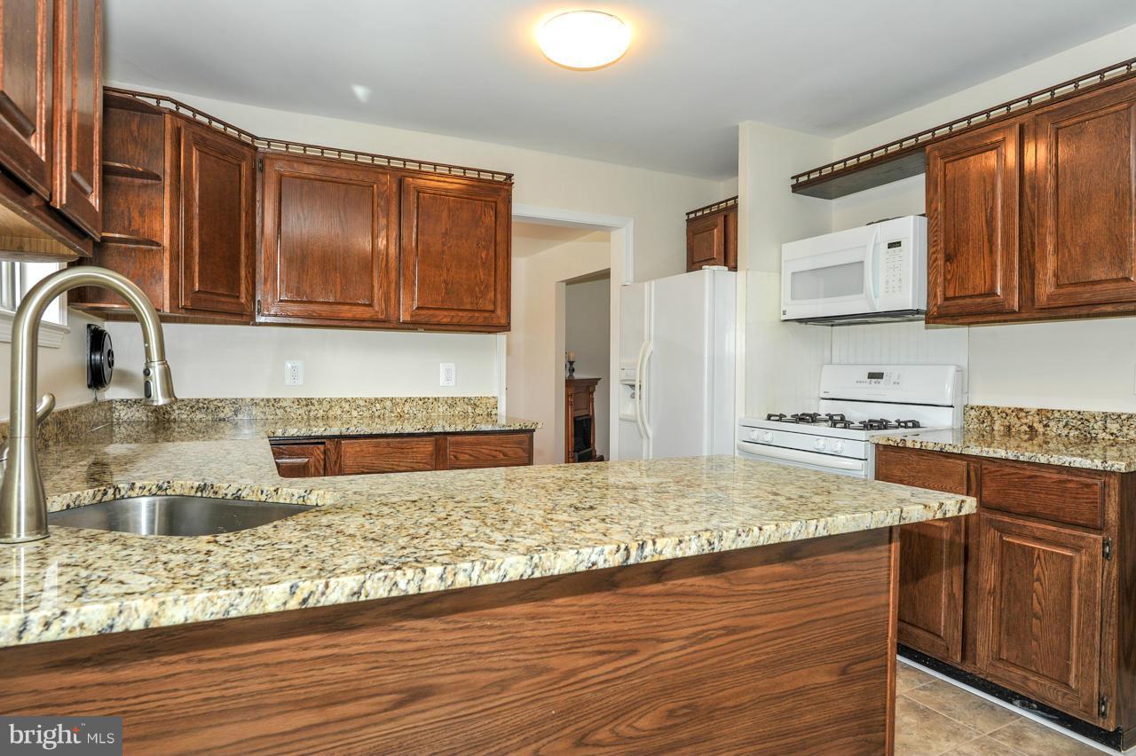 6910 Vancouver Road Springfield, VA 22152 - Photo 8 of 28 a kitchen with stainless steel appliances granite countertop a sink stove and refrigerator