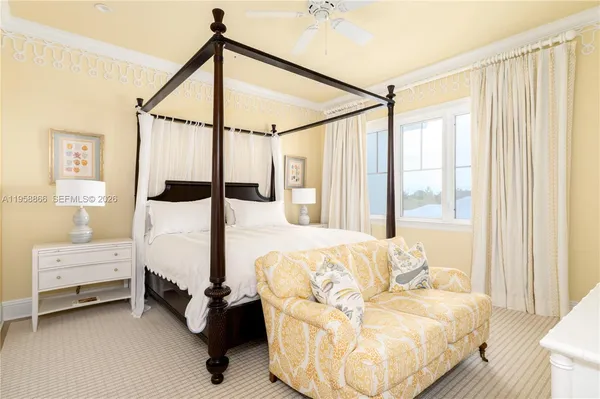 a bedroom with furniture and large window