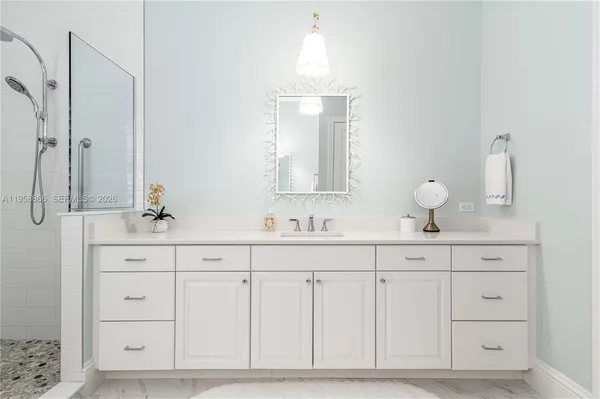 a bathroom with a sink vanity and mirror