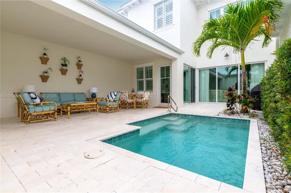 a view of a house with backyard porch and furniture