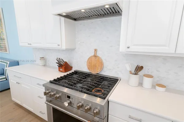 a white stove top oven sitting inside of a kitchen