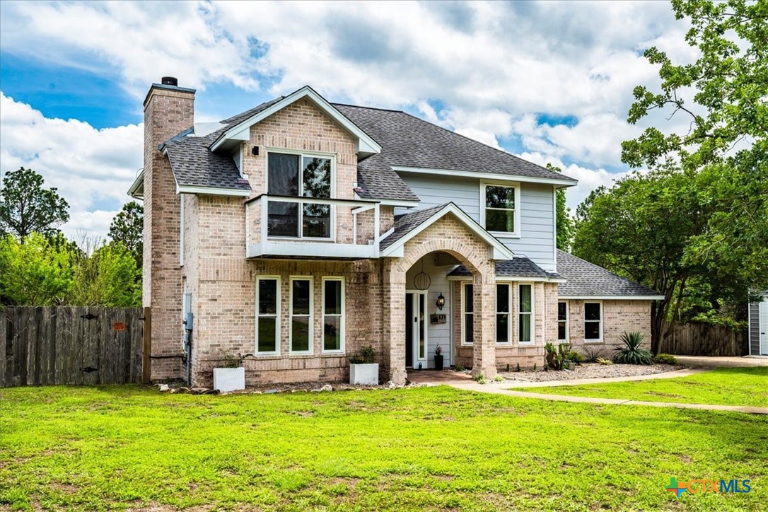 171 Pin Oak Crossing Elgin, TX 78621 - Photo 1 of 38 a front view of a house with a garden