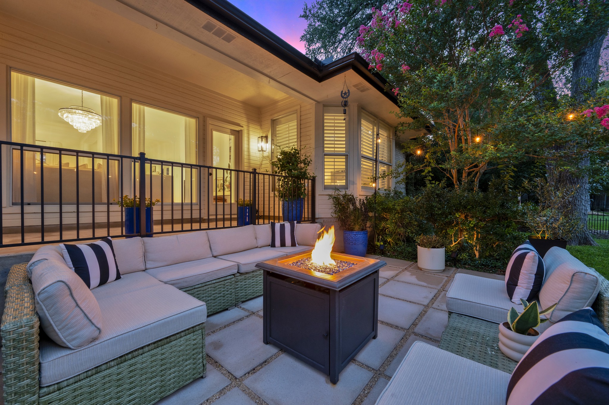 30115 Sawgrass Trail Georgetown, TX 78628 - Photo 19 of 37 An inviting fire pit glows on the patio, complemented by comfortable outdoor seating and mature landscaping.