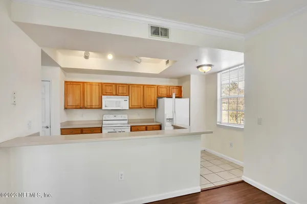 a kitchen with a refrigerator and window