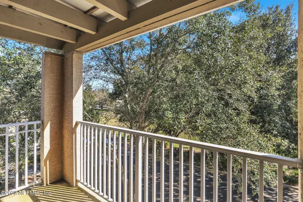 a view of a balcony with wooden floor