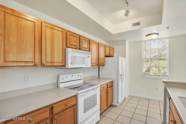 a kitchen with stainless steel appliances granite countertop a refrigerator sink and cabinets