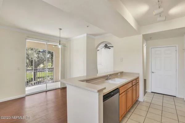 a kitchen with granite countertop a sink and a refrigerator
