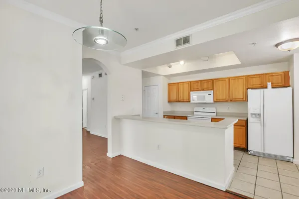 a kitchen with stainless steel appliances a refrigerator and a stove top oven
