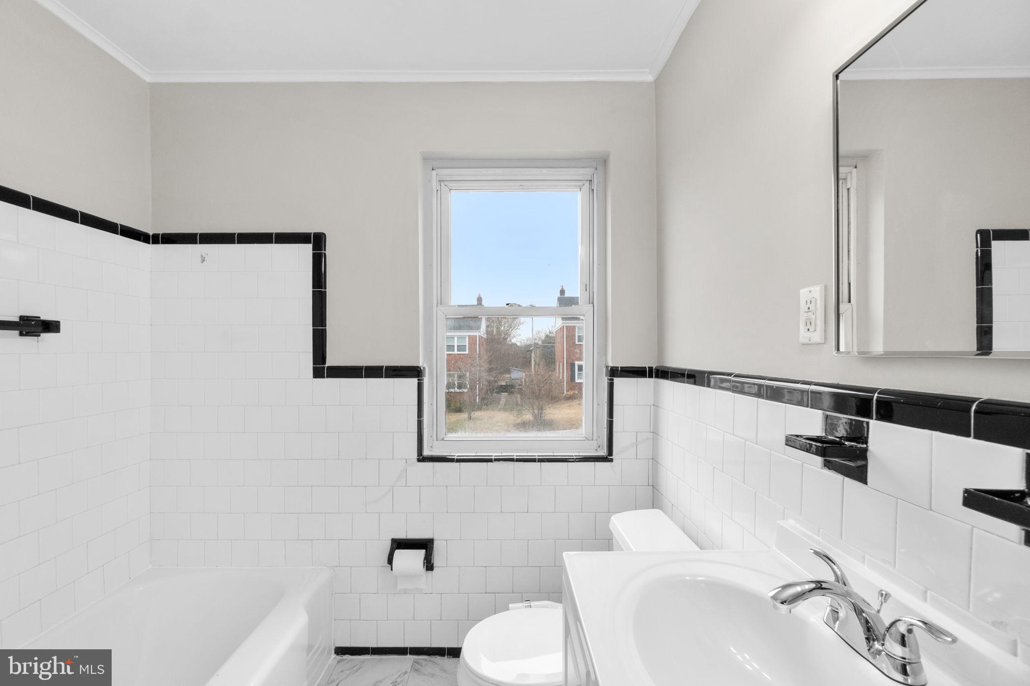 134 Marburth Avenue Baltimore, MD 21286 - Photo 12 of 27 a bathroom with a sink mirror and toilet