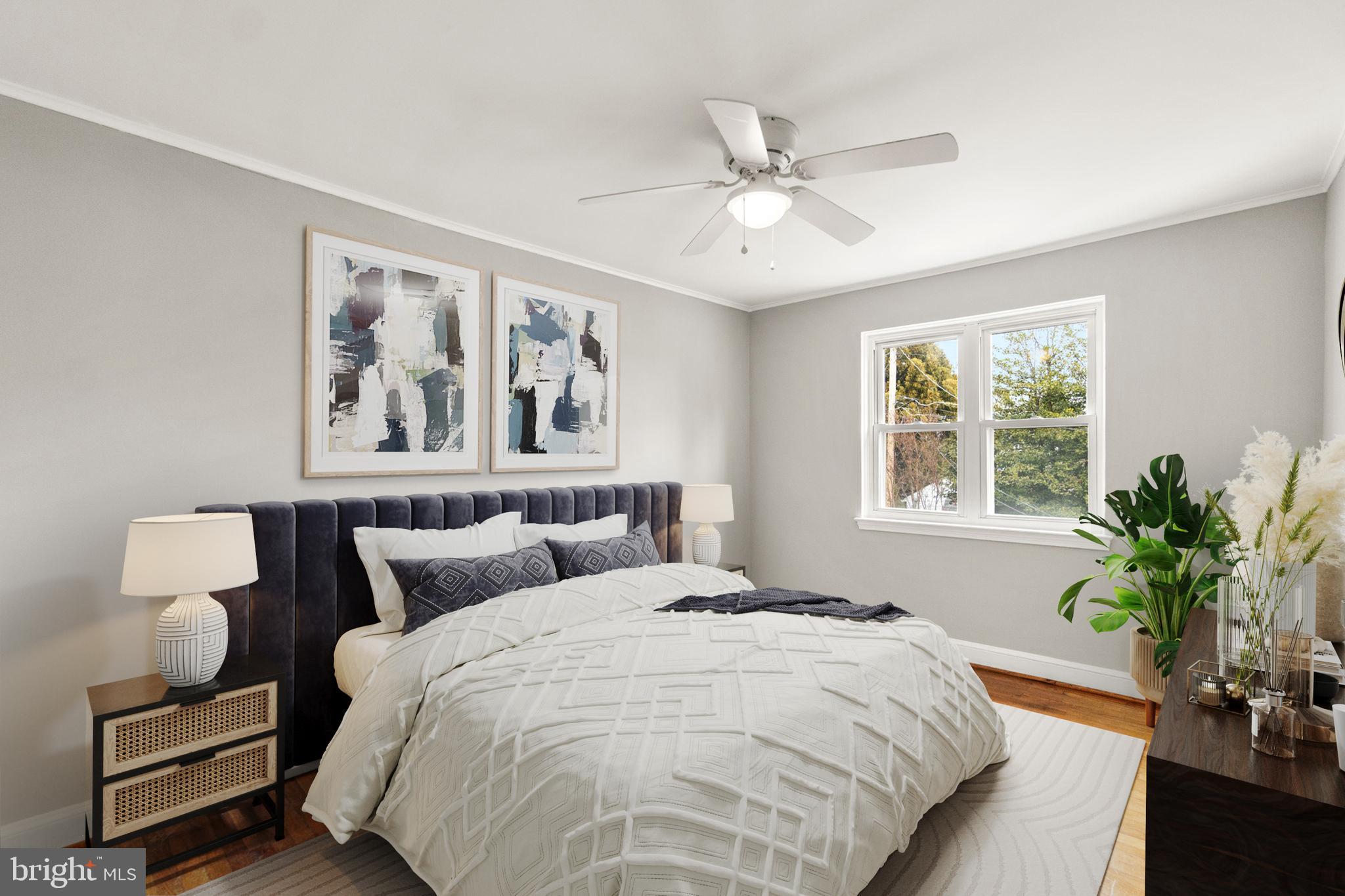 134 Marburth Avenue Baltimore, MD 21286 - Photo 15 of 27 a bedroom with a large bed and a potted plant