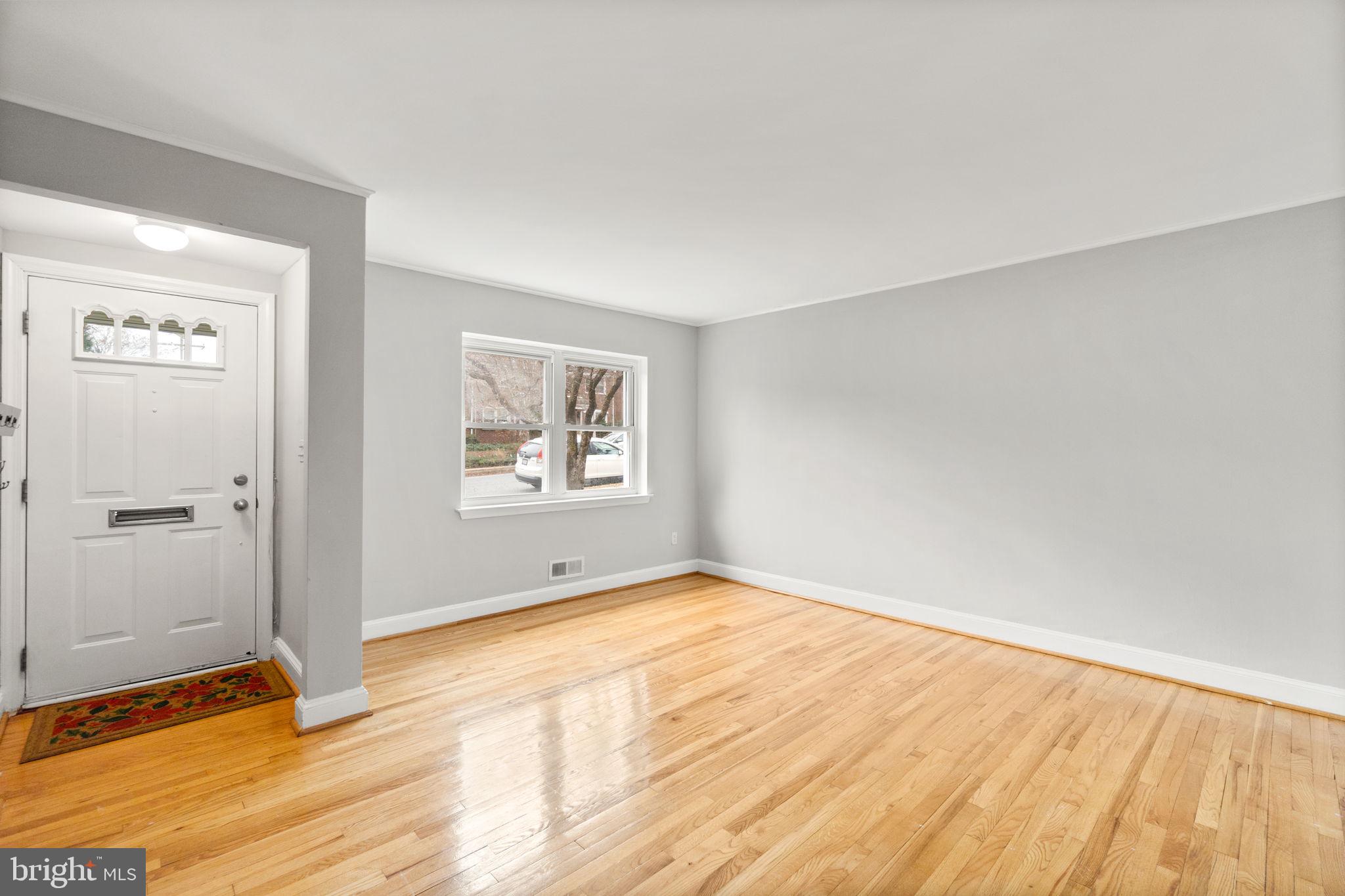 134 Marburth Avenue Baltimore, MD 21286 - Photo 4 of 27 an empty room with wooden floor and windows