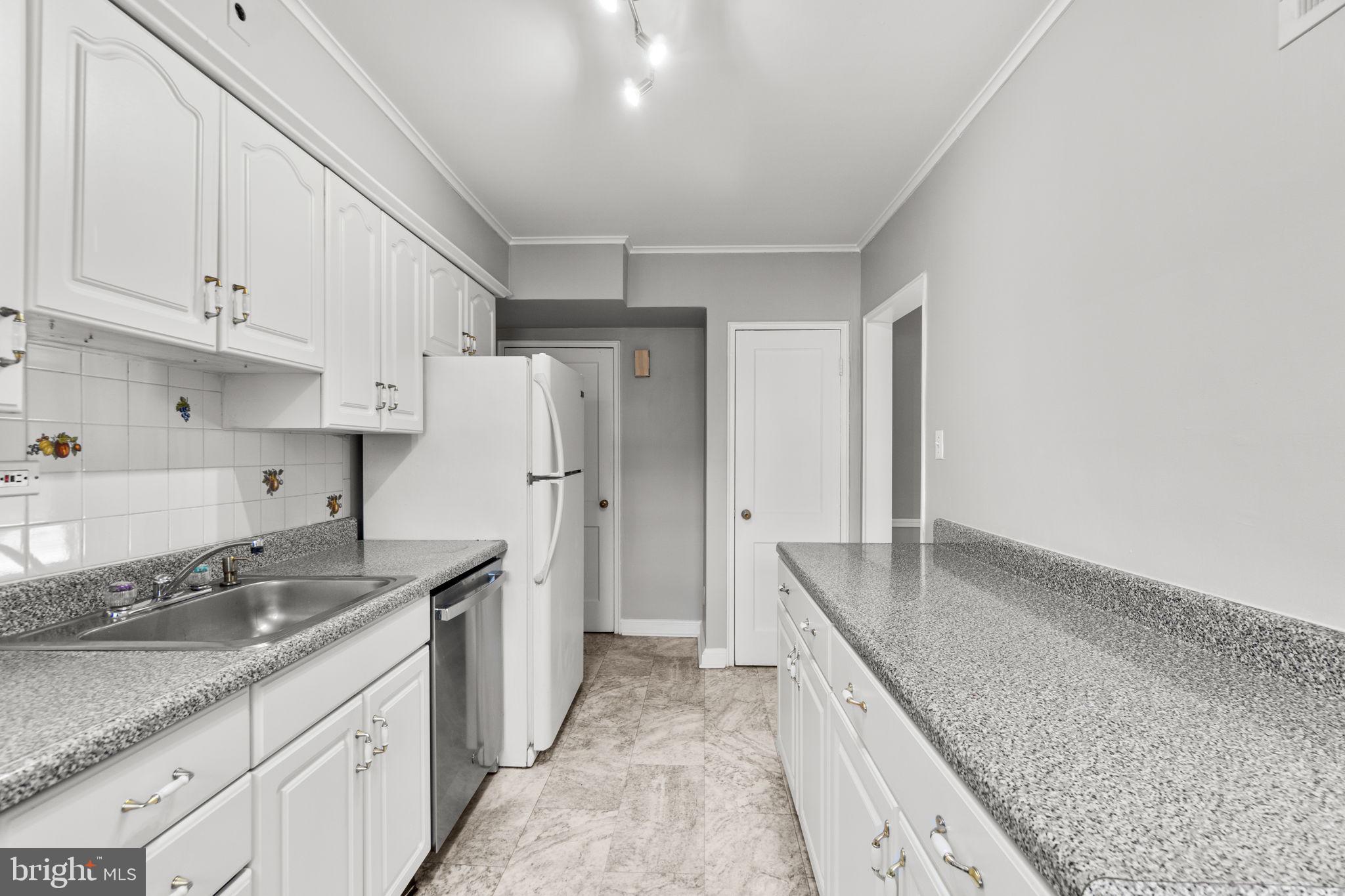 134 Marburth Avenue Baltimore, MD 21286 - Photo 8 of 27 a kitchen with granite countertop a sink stove and refrigerator
