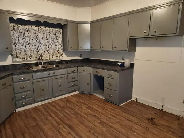 a kitchen with wooden cabinets and a sink