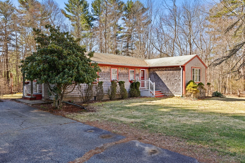 45 King Street Raynham, MA 02767 - Photo 3 of 29 a view of a house with a yard and garage
