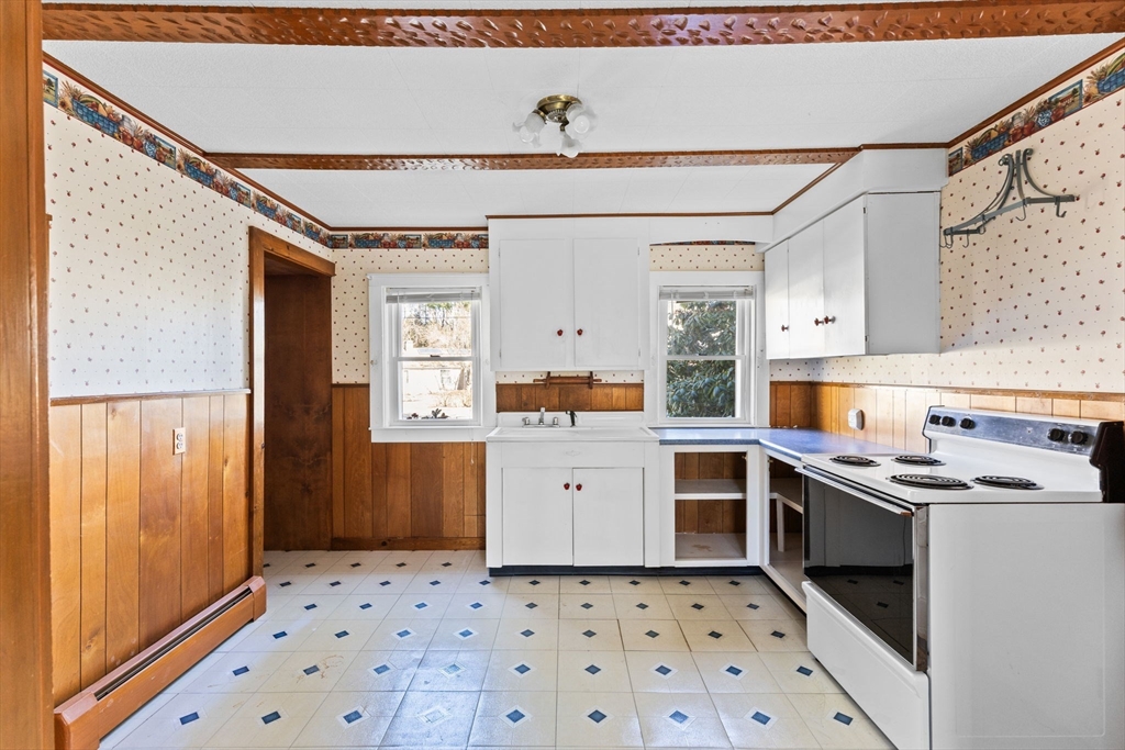 45 King Street Raynham, MA 02767 - Photo 7 of 29 a kitchen with stainless steel appliances a stove a sink and a refrigerator