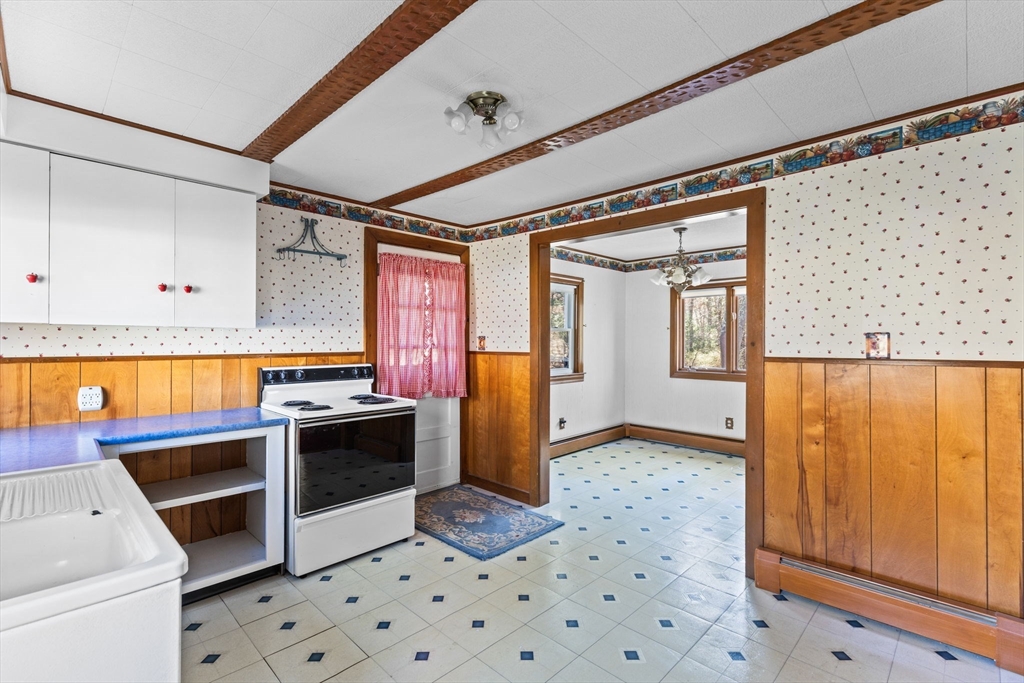 45 King Street Raynham, MA 02767 - Photo 8 of 29 a kitchen with stainless steel appliances granite countertop a stove a sink and a refrigerator