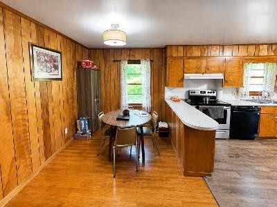 202 Maggart Road Elmwood, TN 38560 - Photo 7 of 34 a dining hall with stainless steel appliances granite countertop a stove top oven a dining table and chairs with wooden floor