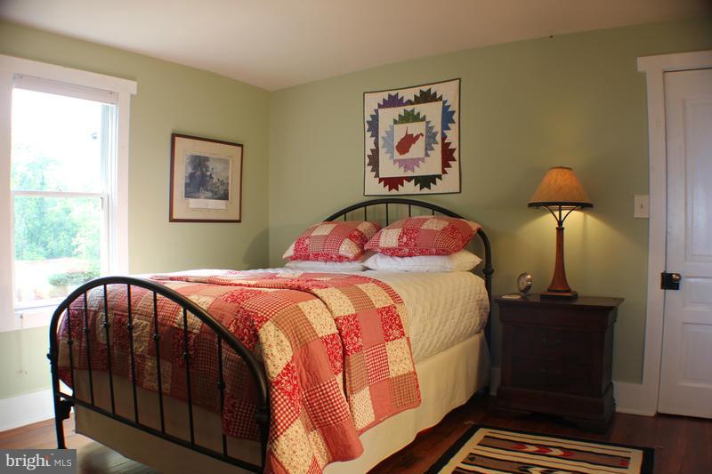 31 Starks Road Washington, VA 22747 - Photo 14 of 30 a bedroom with a bed and a lamp on dresser
