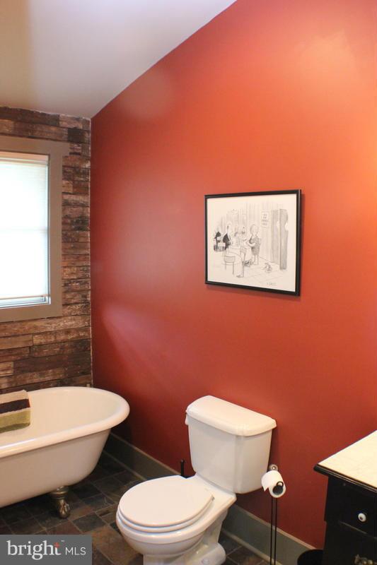 31 Starks Road Washington, VA 22747 - Photo 16 of 30 a white toilet sitting next to a bathroom sink and a mirror
