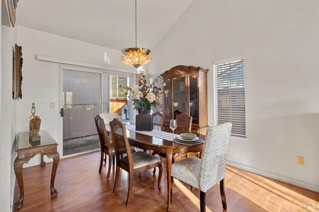a view of a dining room with furniture and chandelier