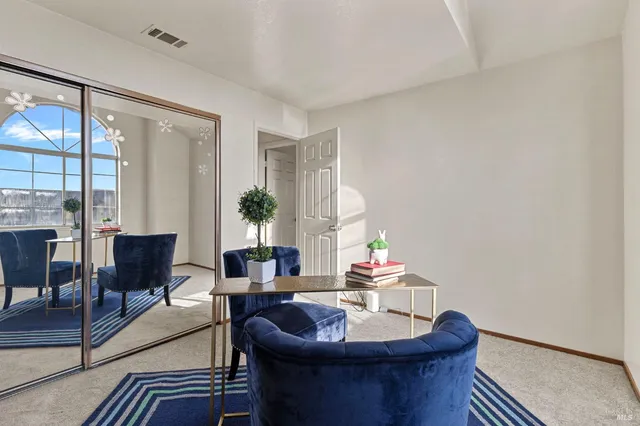 a kitchen with kitchen island granite countertop a stove top oven a sink a dining table and chairs with wooden floor