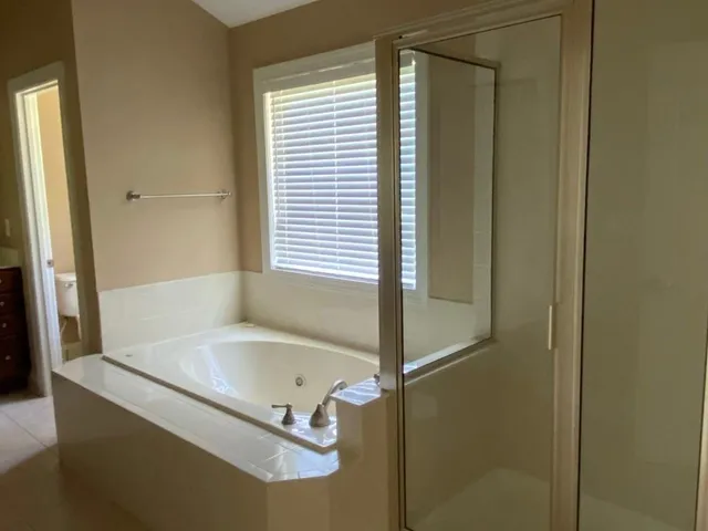a bathroom with a tub and a shower