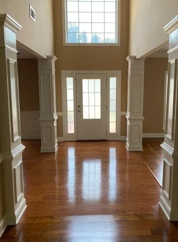 a view of an entryway with wooden floor and a window